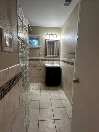 a large kitchen with granite countertop a sink and cabinets
