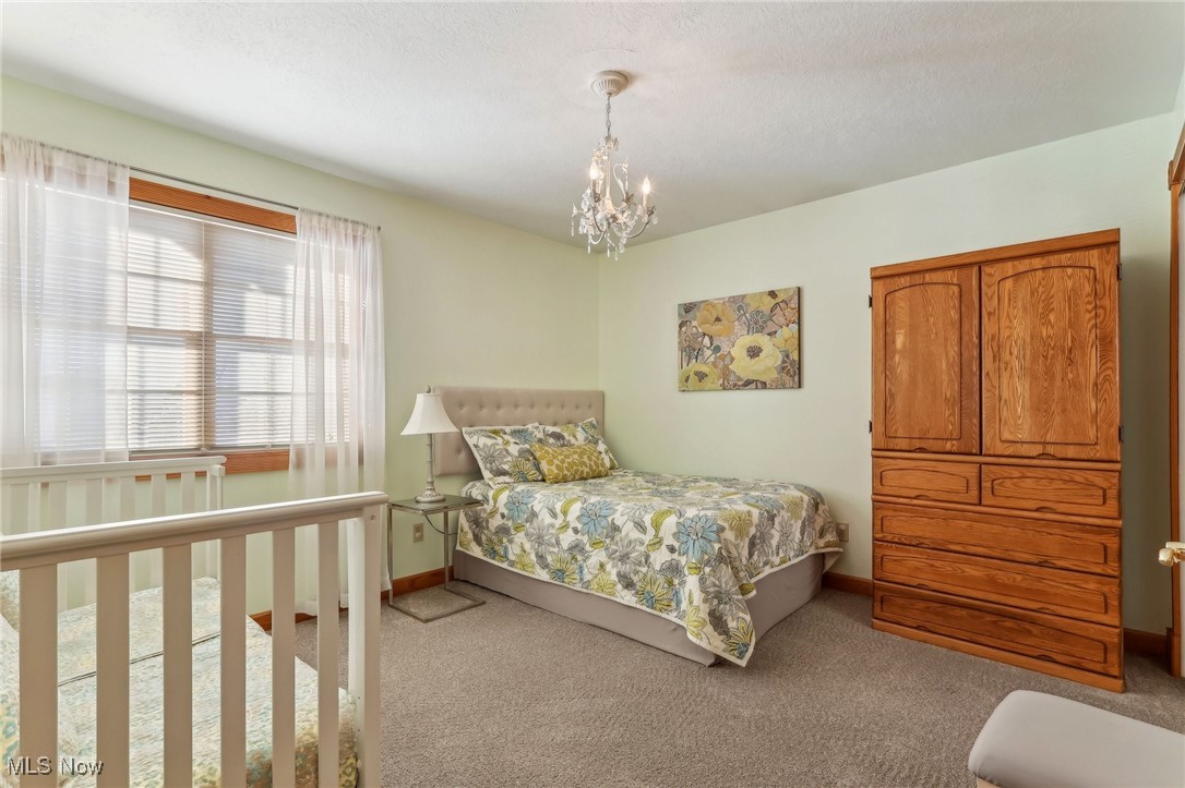 3353 Jens Way Perry, OH 44081 - Photo 26 of 49 Bedroom with a chandelier and light carpet
