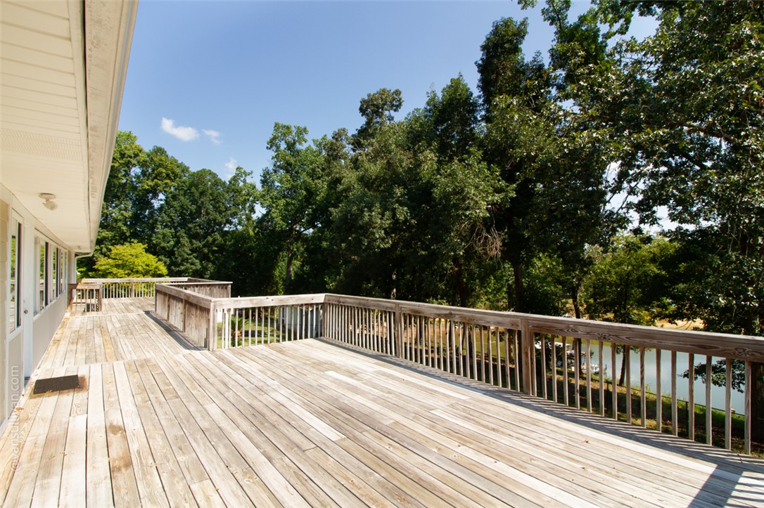 4518 Cove Trail Anderson, SC 29621 - Photo 37 of 49 A spacious wooden deck overlooks lush surrounding trees and a scenic water view.