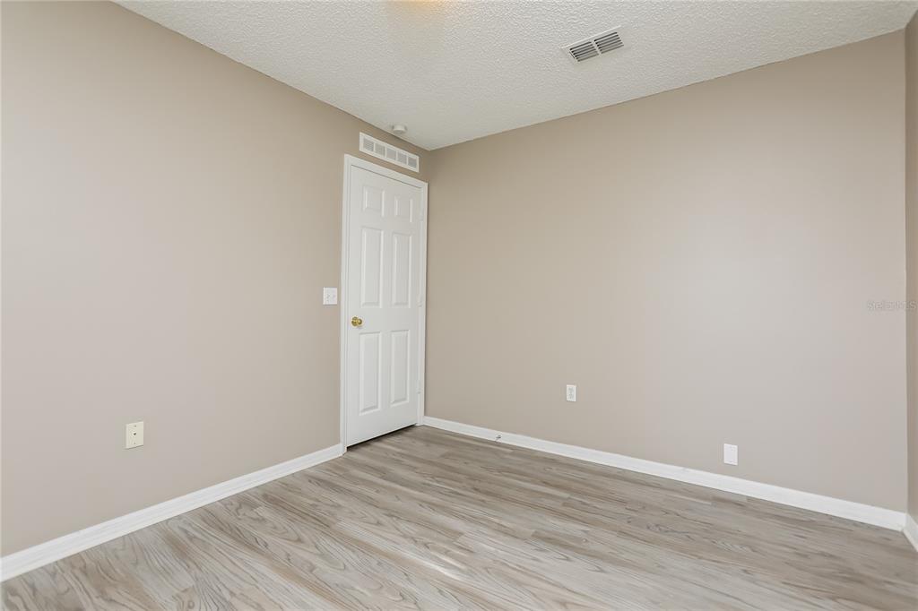 977 Vanderbilt Drive Eustis, FL 32726 - Photo 12 of 16 a view of an empty room with wooden floor