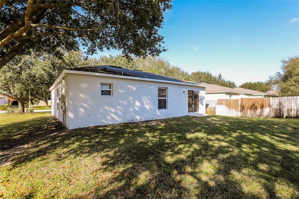 977 Vanderbilt Drive Eustis, FL 32726 - Photo 15 of 16 a backyard of a house with lots of green space