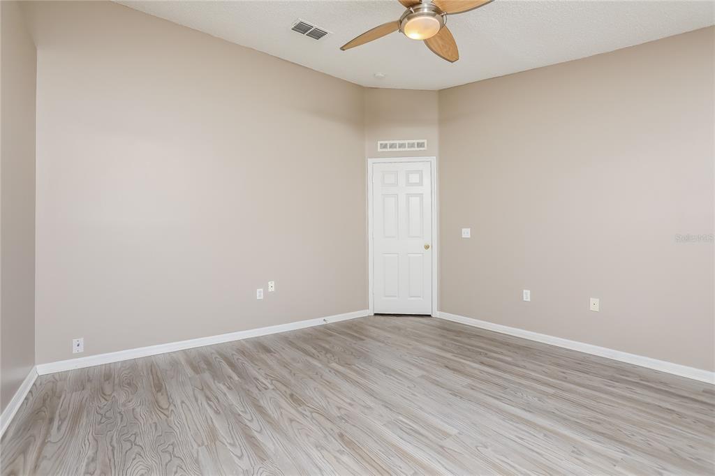 977 Vanderbilt Drive Eustis, FL 32726 - Photo 6 of 16 wooden floor in an empty room