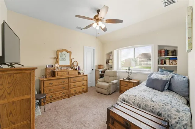 a bedroom with furniture and a window