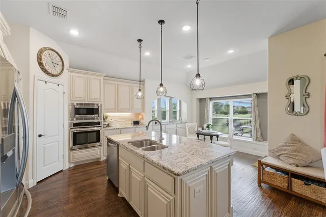 a kitchen with granite countertop a stove and a wooden floor