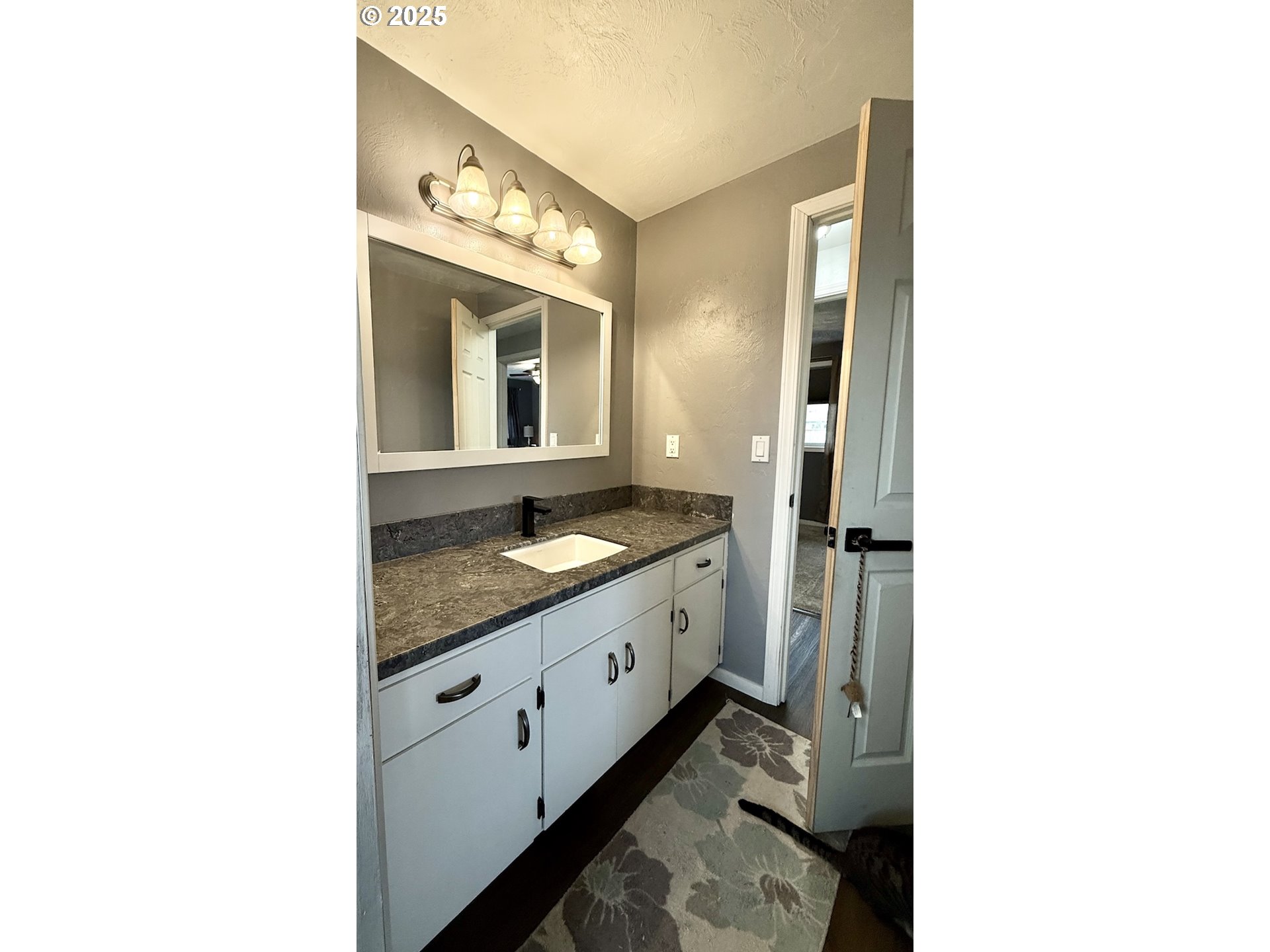 2172 8th Street Springfield, OR 97477 - Photo 21 of 34 a spacious bathroom with a granite countertop sink and a mirror