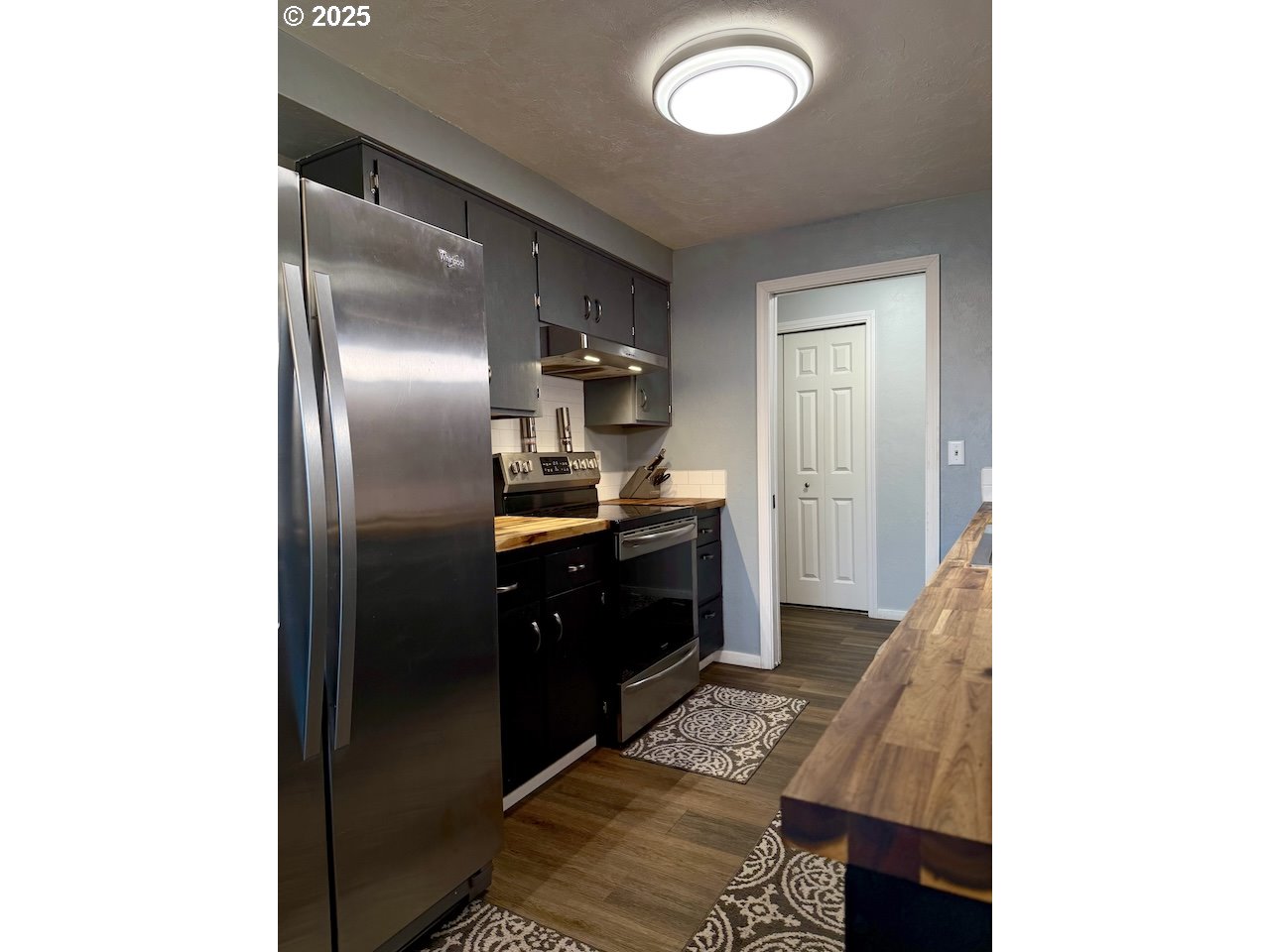 2172 8th Street Springfield, OR 97477 - Photo 6 of 34 a kitchen with stainless steel appliances granite countertop a sink and a refrigerator