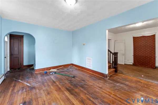 a view of empty room with wooden floor
