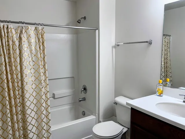 a bathroom with a sink toilet and shower