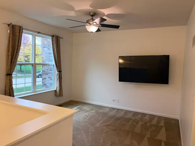a view of a livingroom with furniture and a ceiling fan