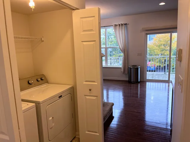 a view of a room with wooden floor and sink