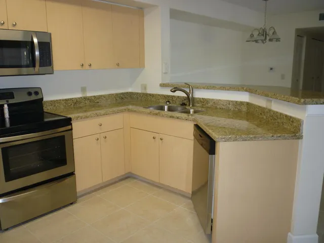 a kitchen with a sink stove and microwave