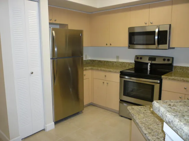 a kitchen with a refrigerator stove and microwave