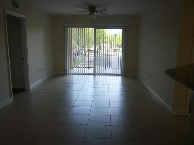 a view of a livingroom with an empty space and a window