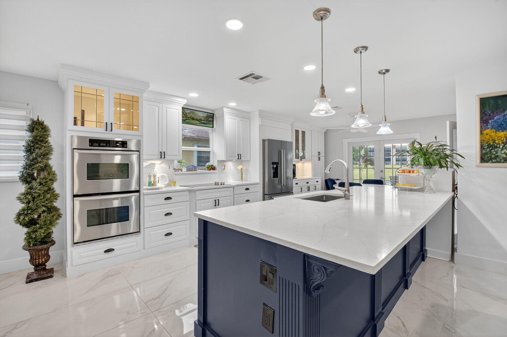 a kitchen with kitchen island a sink appliances and cabinets