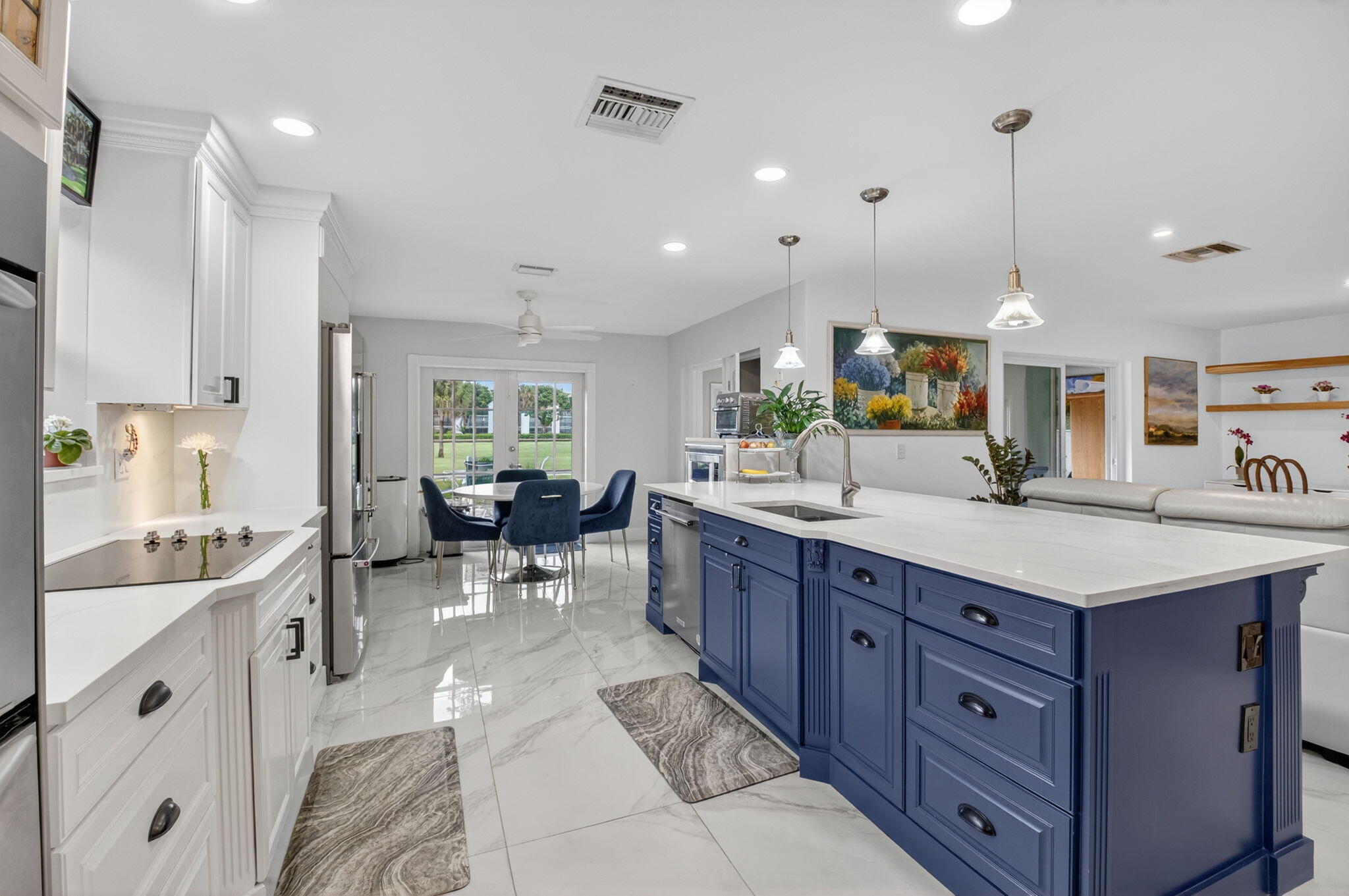 23265 Southwest 61st Avenue Boca Raton, FL 33428 - Photo 11 of 44 a kitchen with counter top space sink and center island