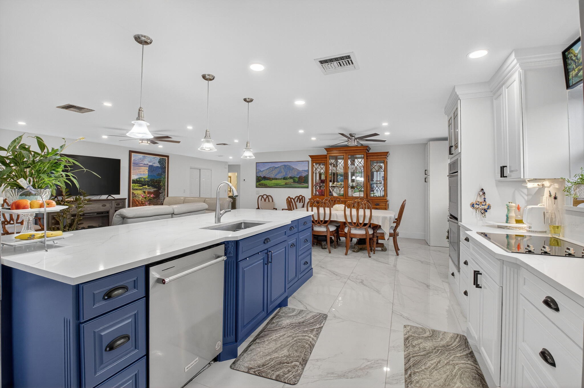 23265 Southwest 61st Avenue Boca Raton, FL 33428 - Photo 13 of 44 a kitchen with kitchen island granite countertop a sink and a refrigerator