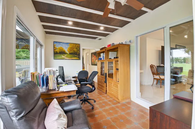 a work room with furniture and a floor to ceiling window