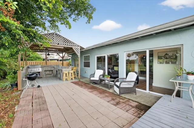 a building outdoor space with patio furniture and potted plants