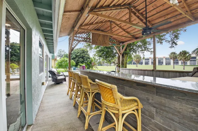 a view of a swimming pool with outdoor seating and a patio