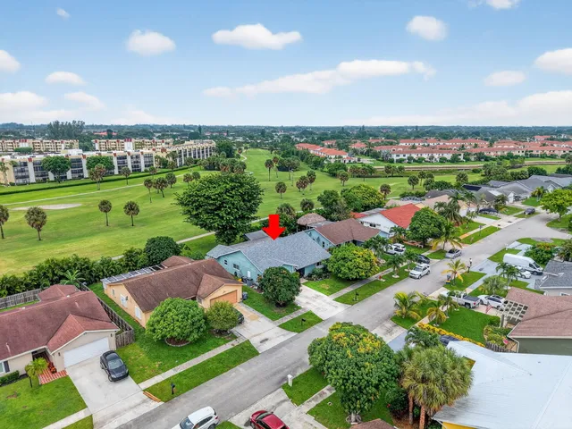 an aerial view of a city with lots of green space