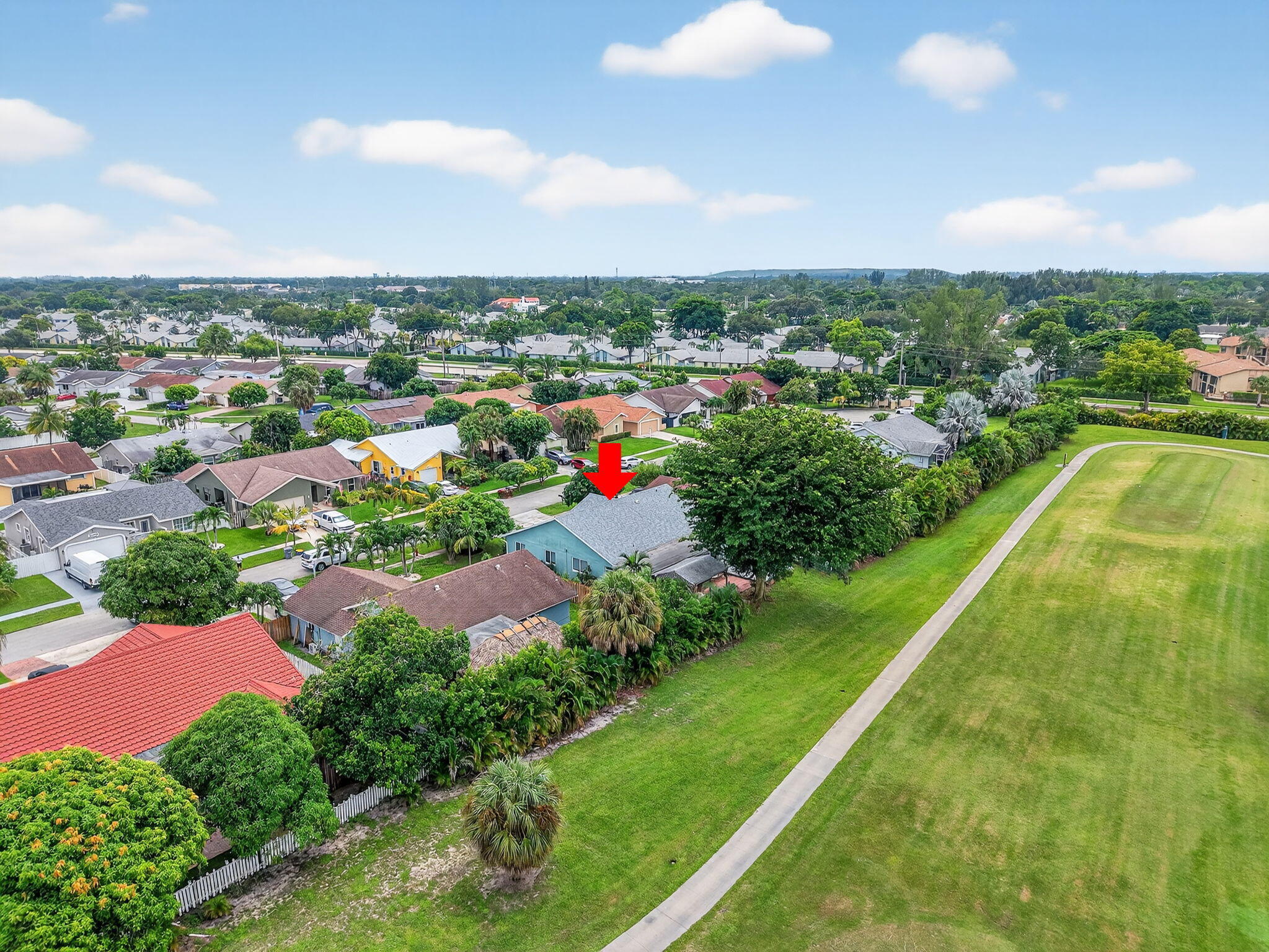 23265 Southwest 61st Avenue Boca Raton, FL 33428 - Photo 42 of 44 an aerial view of residential houses with outdoor space and trees