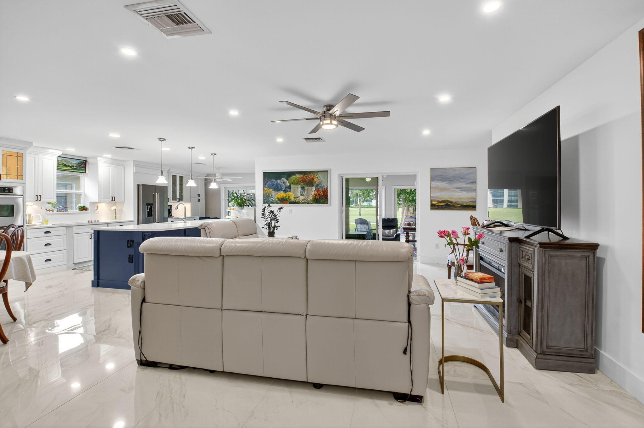 23265 Southwest 61st Avenue Boca Raton, FL 33428 - Photo 5 of 44 a living room with furniture a flat screen tv and a table