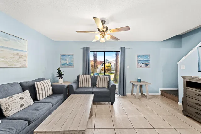 a living room with furniture a dining table and a fireplace