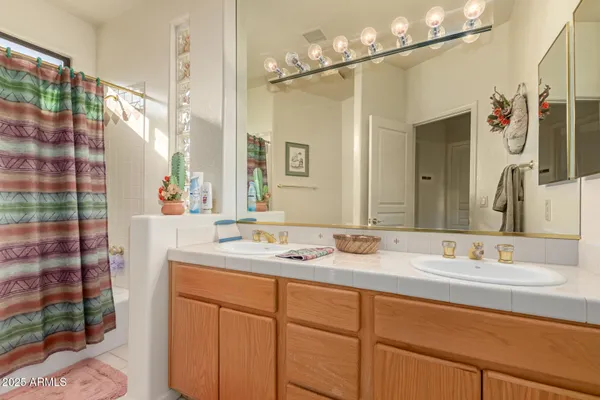 a bathroom with a sink double vanity and a mirror