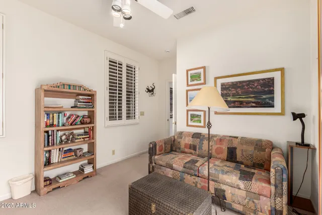 a living room with furniture a couch and a bookshelf