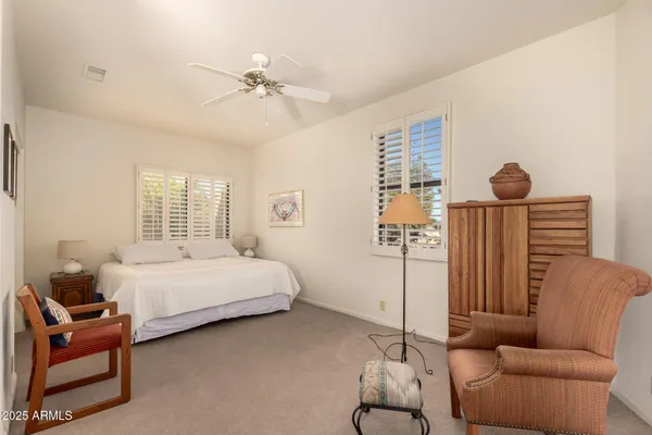 a bedroom with furniture and a window