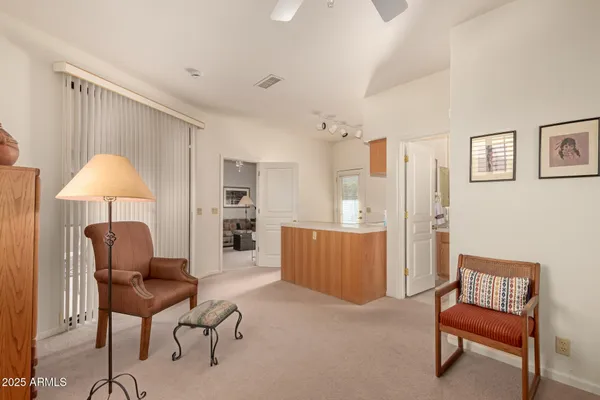 a living room with furniture and a kitchen view