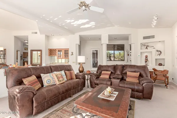 a living room with furniture and a chandelier