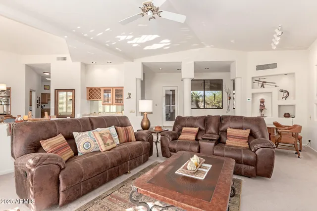 a living room with furniture and a chandelier