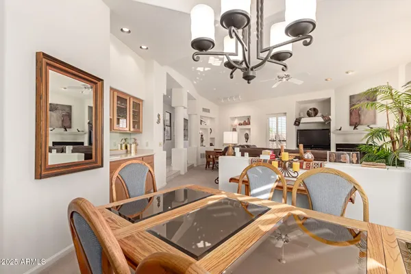 a living room with lots of furniture and ceiling fan