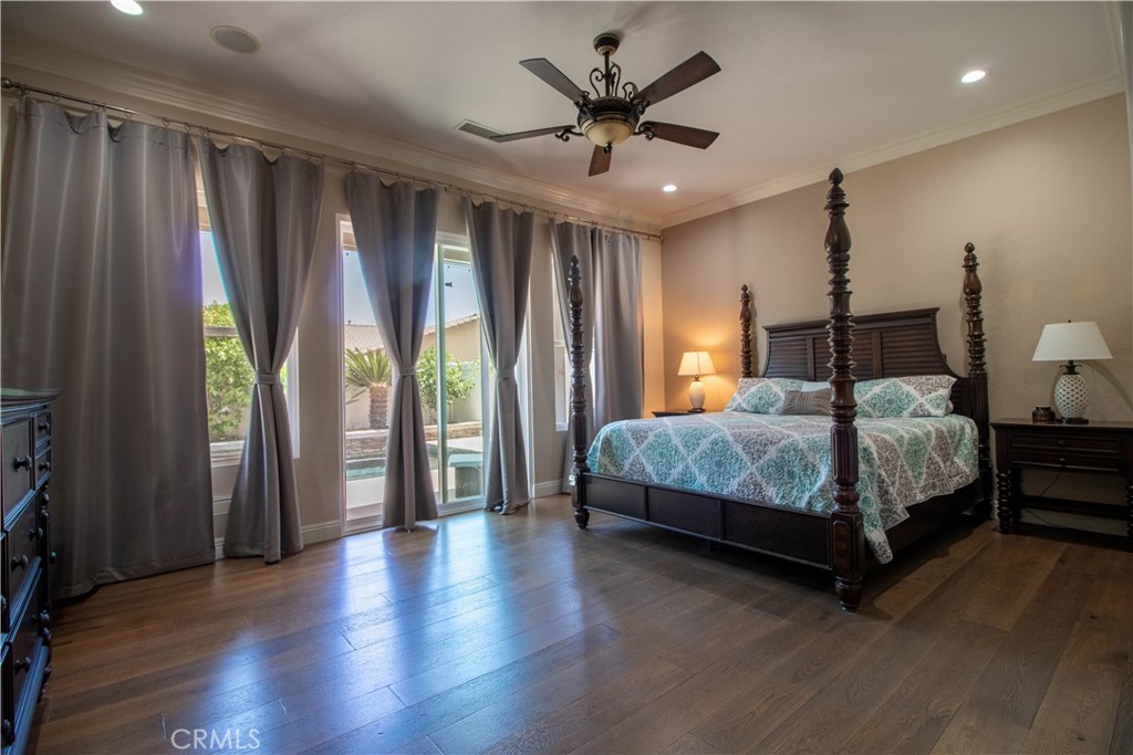 33699 Spring Brook Circle Temecula, CA 92592 - Photo 35 of 83 a bedroom with a large bed and a chandelier