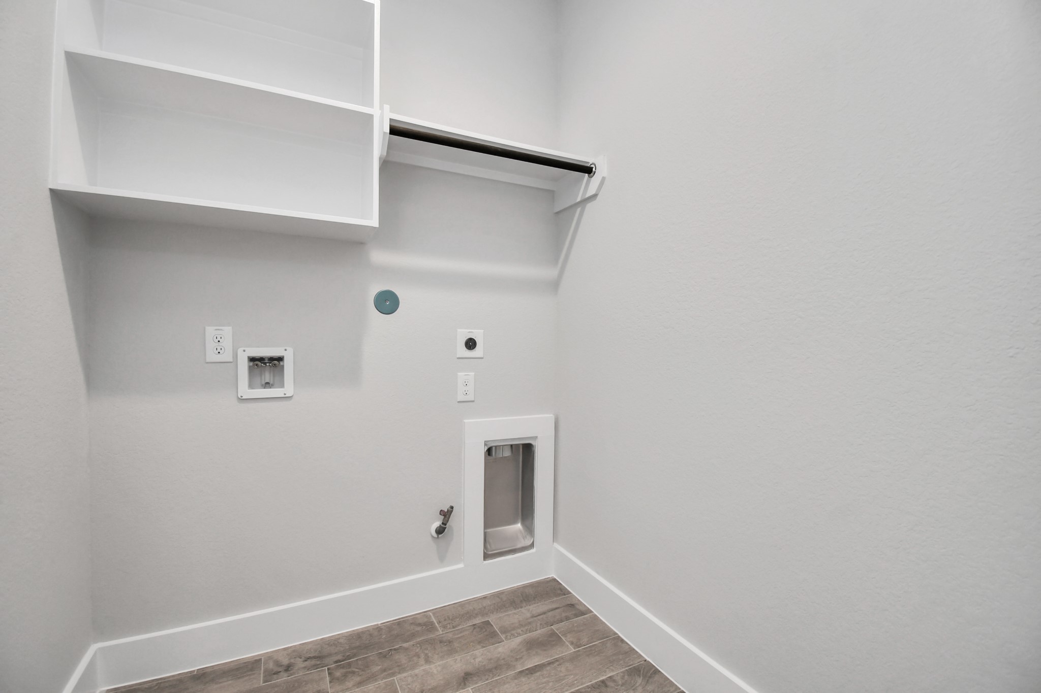 3103 Native Spg Drive Spring, TX 77373 - Photo 35 of 36 A perfect blend of functionality and comfort. Capture the essence of easy living with a first-floor laundry room, thoughtfully equipped with shelving for effortless organization. Both electric and gas connections available. Sample photo of completed home with similar floor plan. Actual colors and selections may vary.