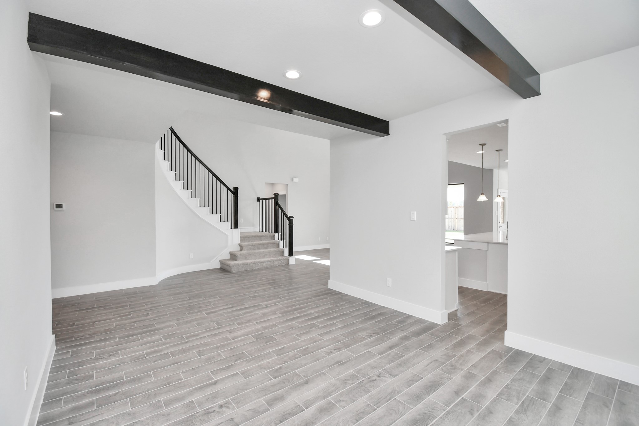 3103 Native Spg Drive Spring, TX 77373 - Photo 7 of 36 Create lasting memories with your family and friends at the dining table! This expansive dining room showcases sophisticated flooring, custom paint, and seamlessly connects to the family room and kitchen, providing an open and inviting atmosphere. Sample photo of completed home with similar floor plan. Actual colors and selections may vary.