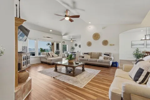 a living room with furniture a fireplace and a flat screen tv