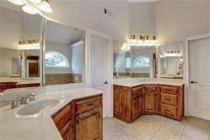 802 Pathview Court Dacula, GA 30019 - Photo 48 of 56 a spacious bathroom with a granite countertop sink and a mirror