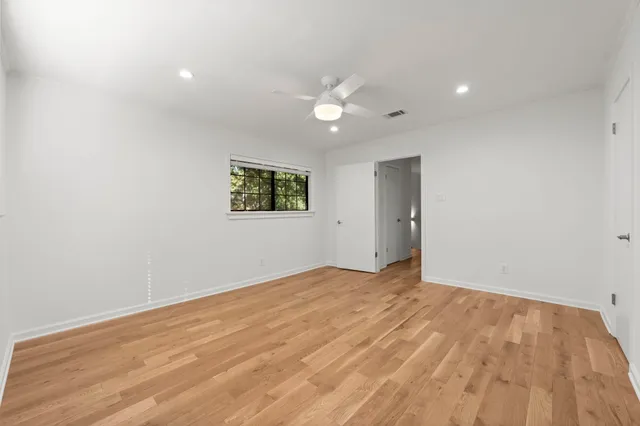 a view of empty room with wooden floor