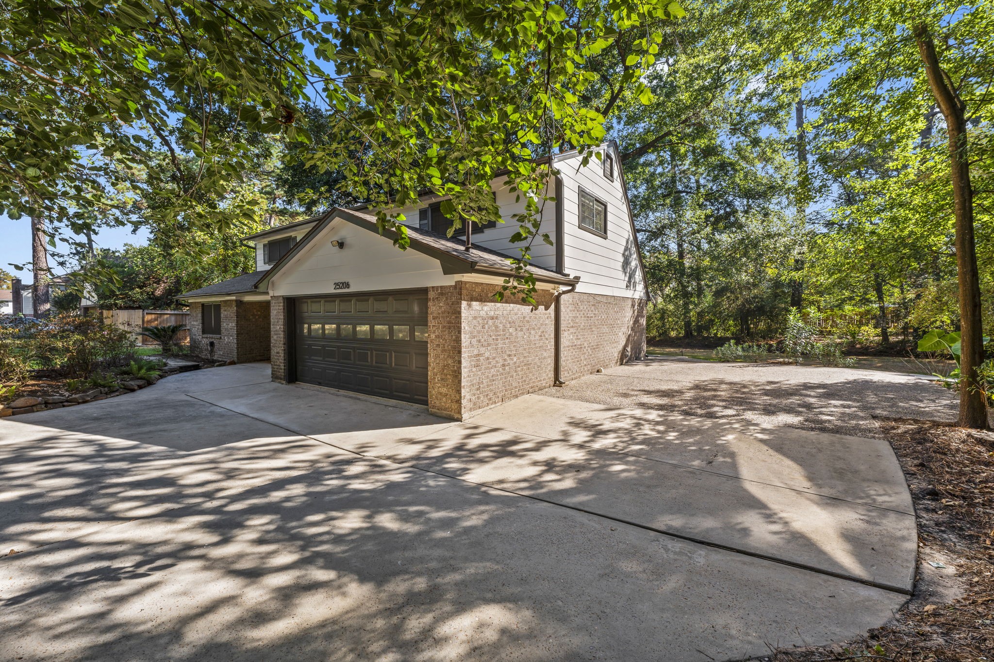 25206 Spring Ridge Drive Spring, TX 77386 - Photo 4 of 37 a front view of a house with a yard and garage