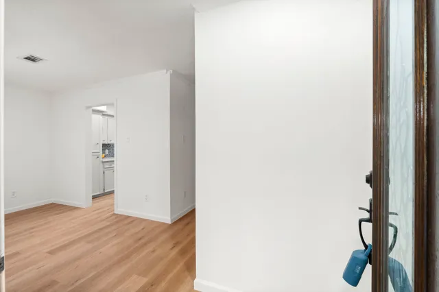 a view of a hallway with wooden floor