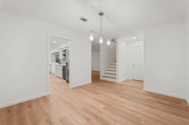 a view of a backyard with large trees