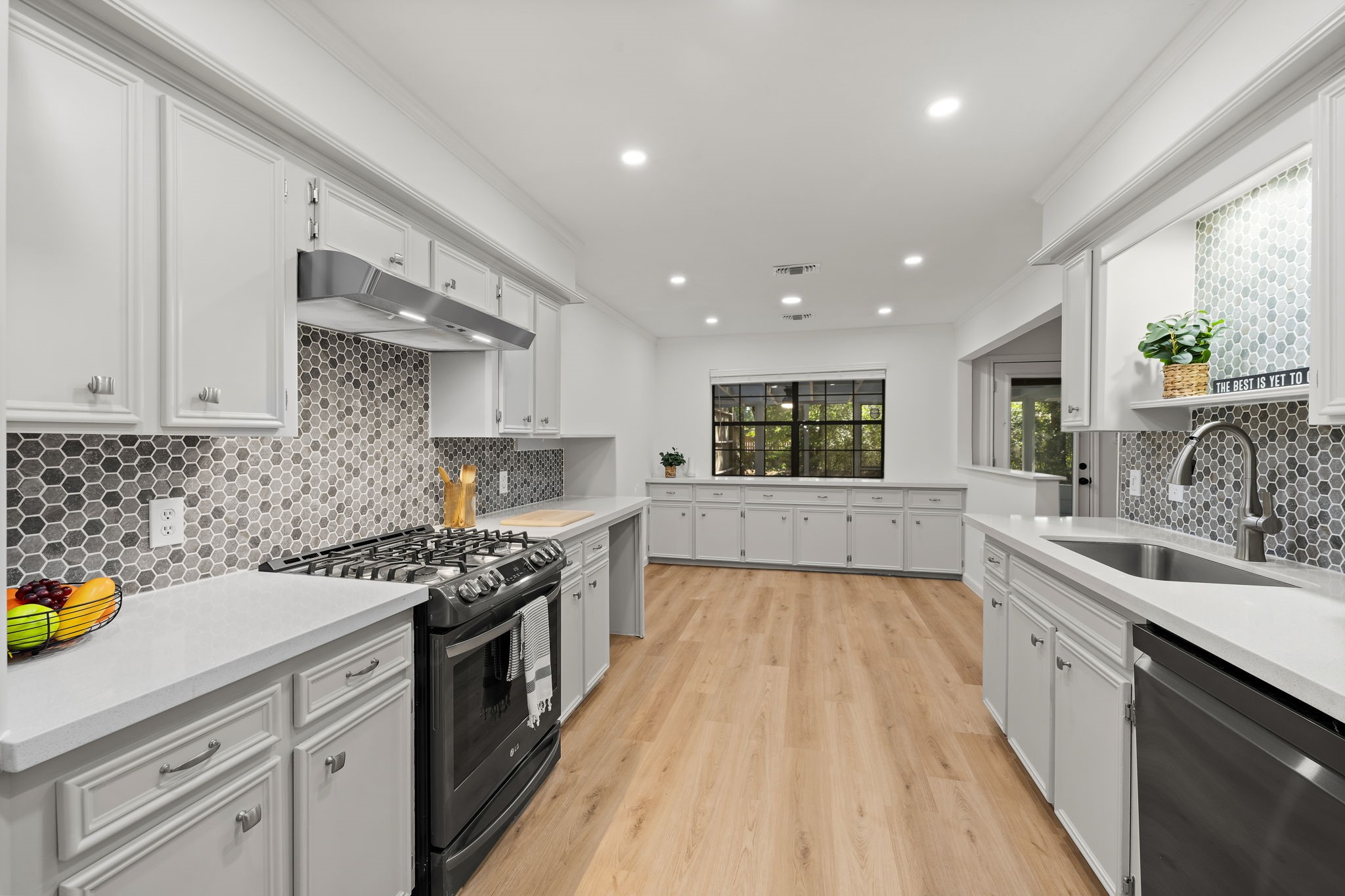 25206 Spring Ridge Drive Spring, TX 77386 - Photo 7 of 37 a kitchen with a sink a counter top space stainless steel appliances and cabinets