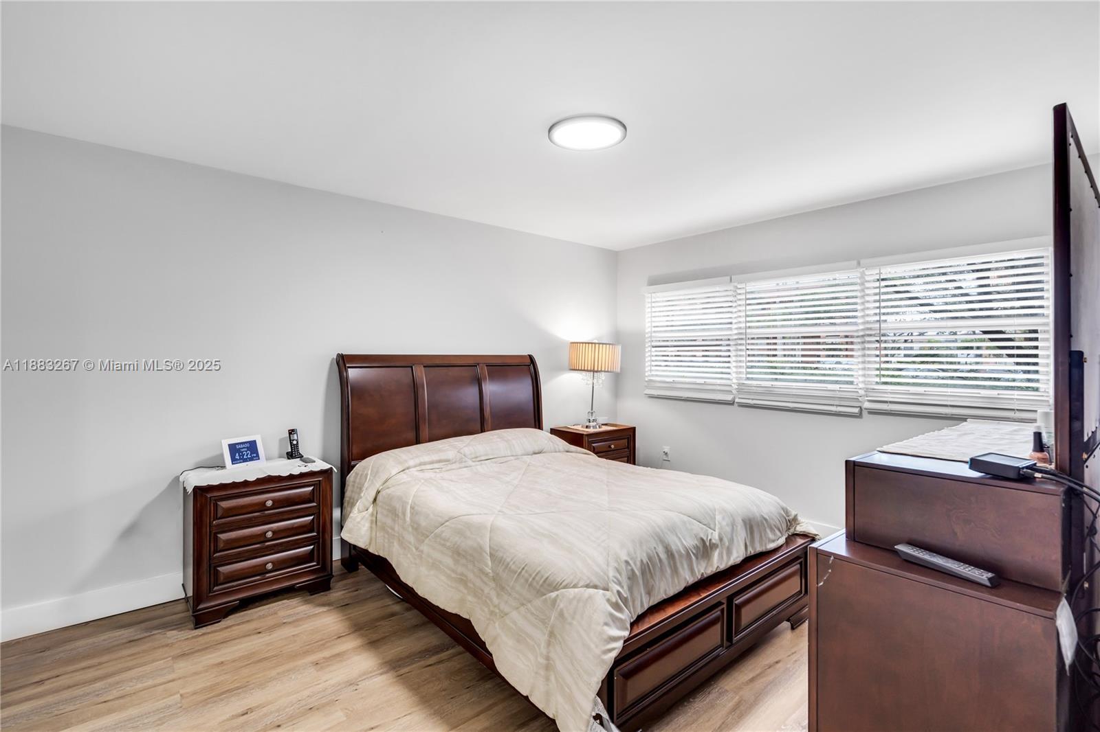 701 Southwest 142nd Avenue, Unit 108S Pembroke Pines, FL 33027 - Photo 15 of 25 a bedroom with a bed and a night stand