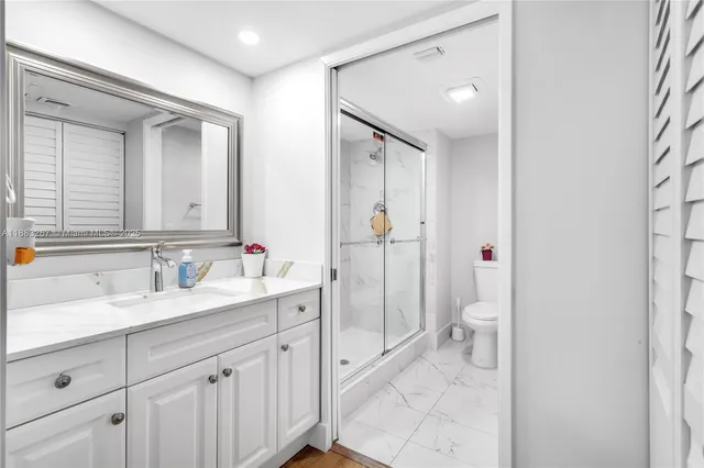 a spacious bathroom with a granite countertop sink mirror and toilet