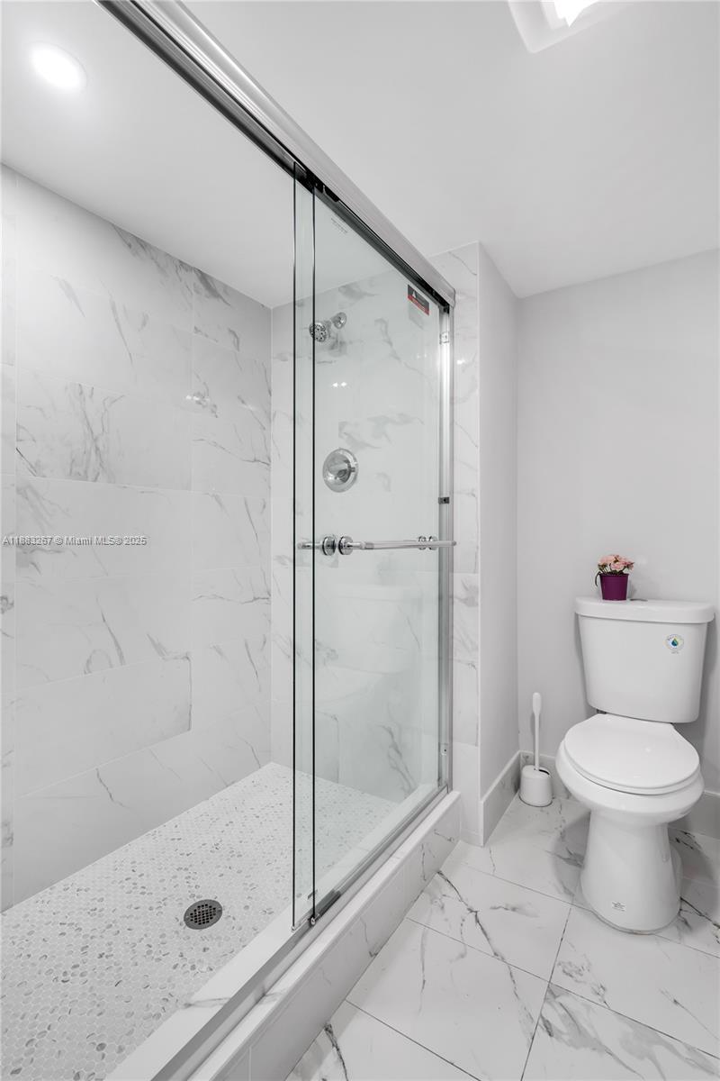 701 Southwest 142nd Avenue, Unit 108S Pembroke Pines, FL 33027 - Photo 18 of 25 a bathroom with a shower and a toilet