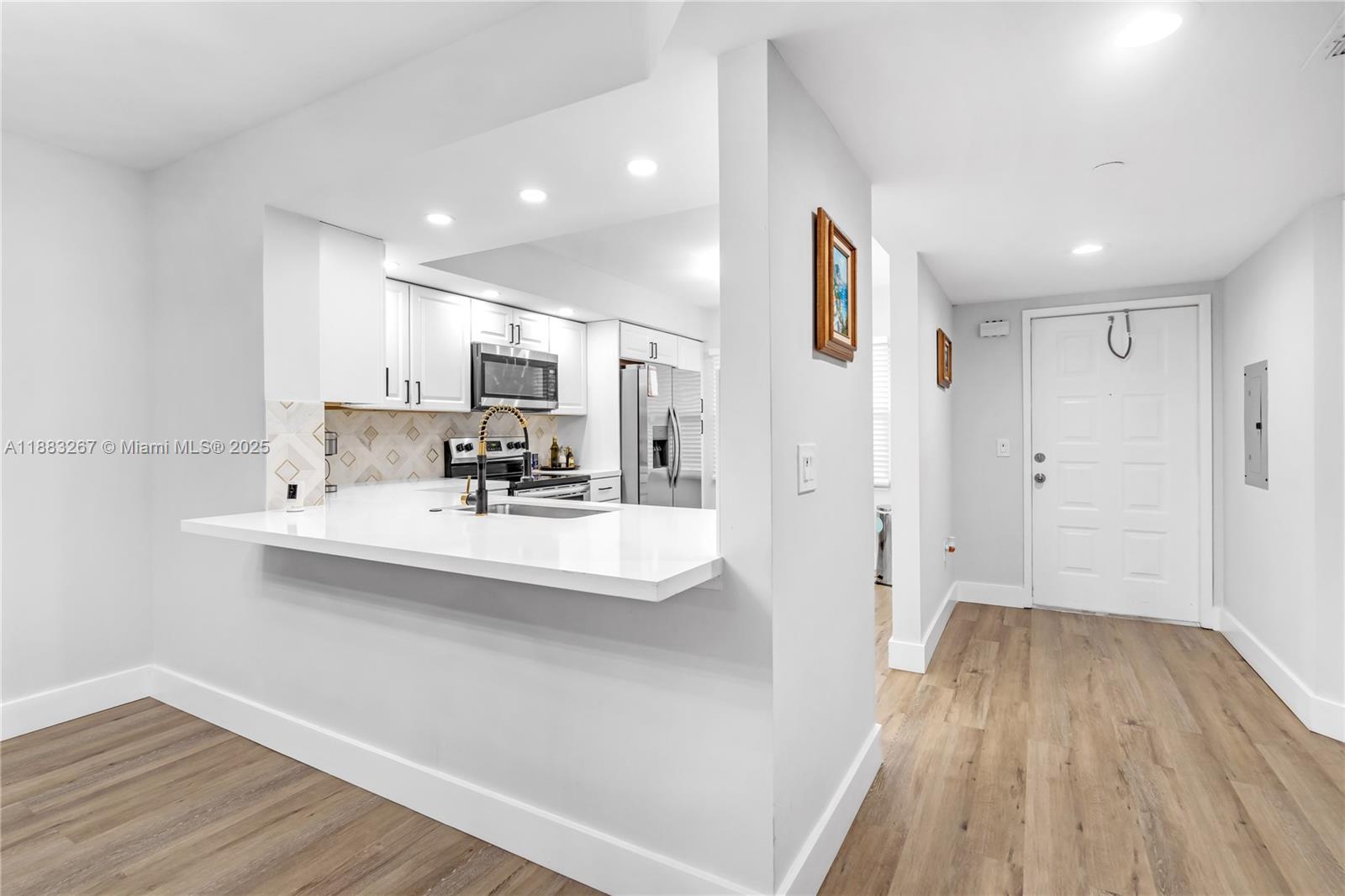 701 Southwest 142nd Avenue, Unit 108S Pembroke Pines, FL 33027 - Photo 4 of 25 a bathroom with a sink mirror and shower