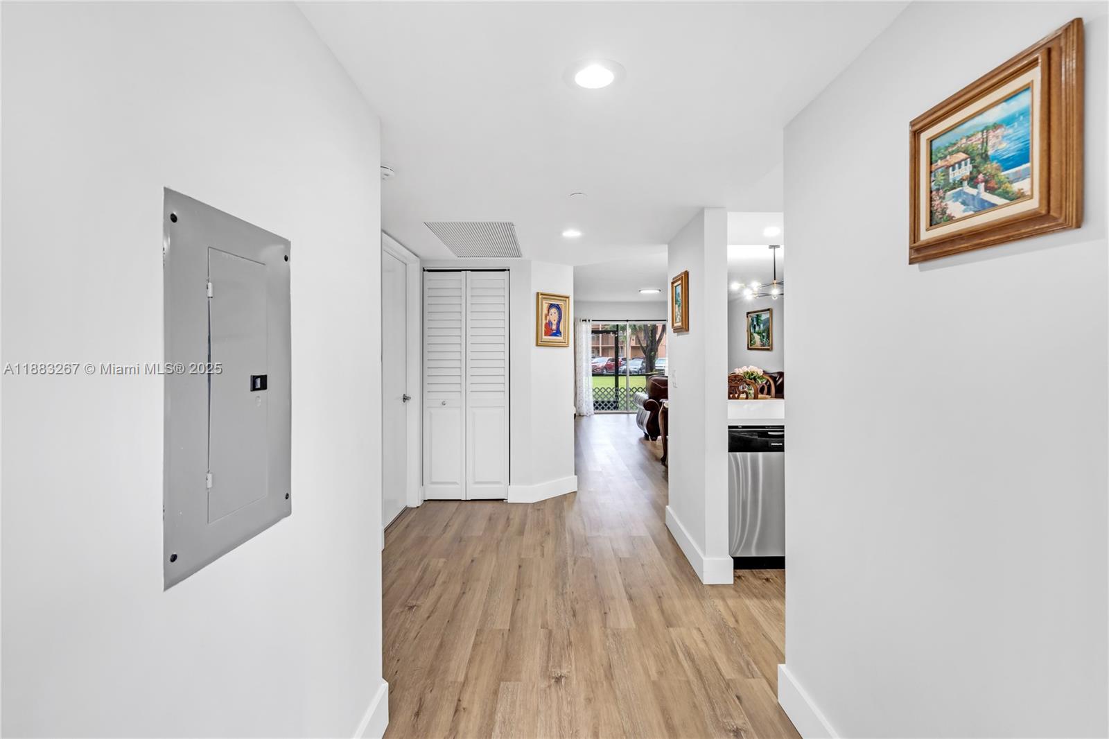701 Southwest 142nd Avenue, Unit 108S Pembroke Pines, FL 33027 - Photo 6 of 25 a view of a hallway with wooden floor