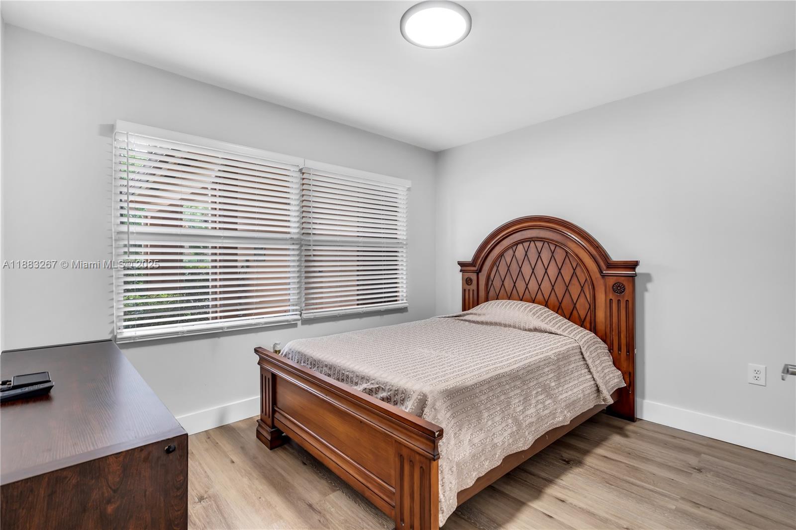 701 Southwest 142nd Avenue, Unit 108S Pembroke Pines, FL 33027 - Photo 7 of 25 a bedroom with a bed and a window